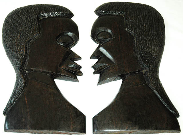 Hand carved side masks in Ebony